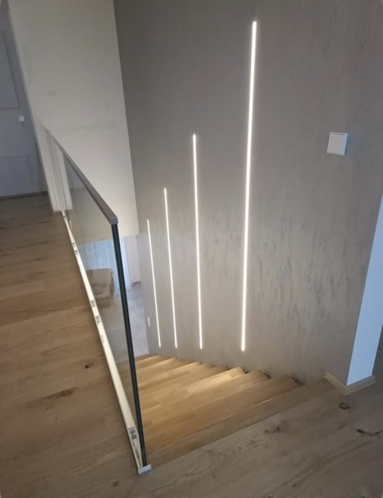 Staircase landing with vertical LED wall accents